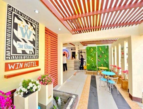 a lobby of a hotel with people walking through it at Win Hotel Phayao in Phayao