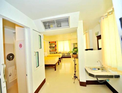 a hospital room with two sinks and a living room at Win Hotel Phayao in Phayao