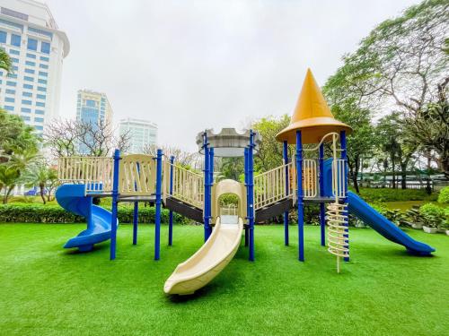 a playground in a park with a slide at Hanoi Daewoo Hotel in Hanoi