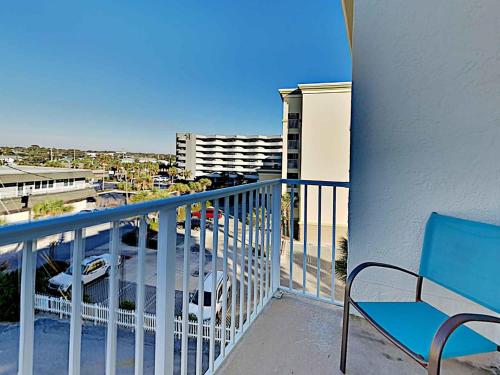 a balcony with a chair and a view of a parking lot at Aqua Villa #401 in Fort Walton Beach