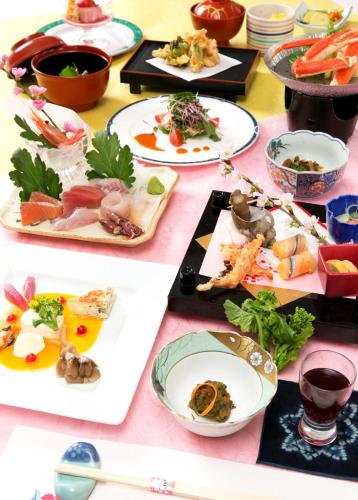 a table with many plates of food on it at Akakura Hotel in Myoko