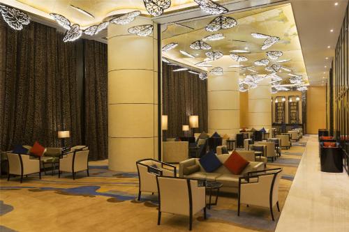 a lobby with chairs and couches in a building at Wyndham Chongqing Yuelai in Chongqing
