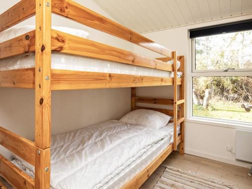 a bedroom with two bunk beds and a window at 8 person holiday home in Vig-By Traum in Vig