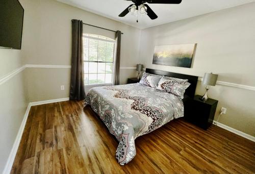 a bedroom with a bed and a ceiling fan at Beautiful Beach house with heated pool in Jacksonville