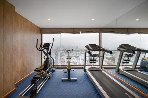 a gym with two treadmills and two ellipticals at Diamond Sea Hotel in Da Nang
