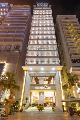 a view of a hotel at night with two tall buildings at Diamond Sea Hotel in Da Nang