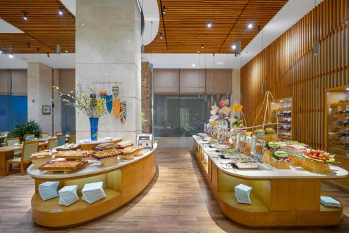 a buffet line with sandwiches and pastries in a restaurant at Diamond Sea Hotel in Da Nang
