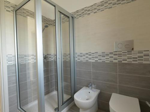 a bathroom with a shower and a toilet and a sink at Holiday Home Floridia with Private Pool in Floridia