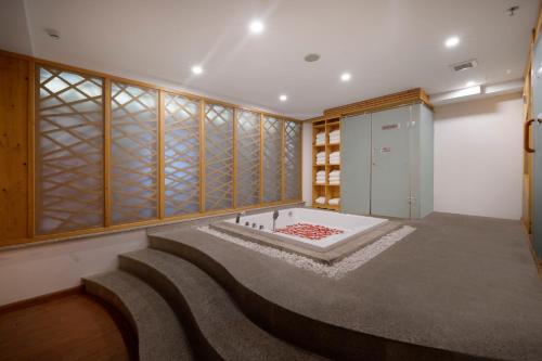 a room with a bath tub and a walk in closet at Diamond Sea Hotel in Da Nang
