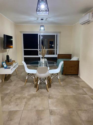 a living room with a glass table and chairs at Edificio Giu 3 in San Salvador de Jujuy