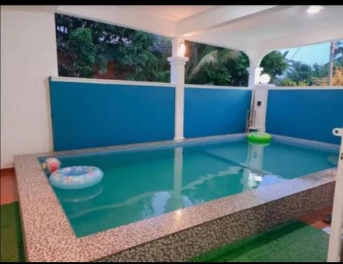 a pool in a house with a swimming pool at D'Diana Homestay in Port Dickson