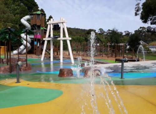 a water park with a slide and a water fountain at Riverlin Estate in Warburton