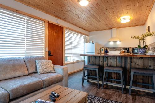 a living room with a couch and a kitchen at Terimore Lodging by the Sea in Tillamook