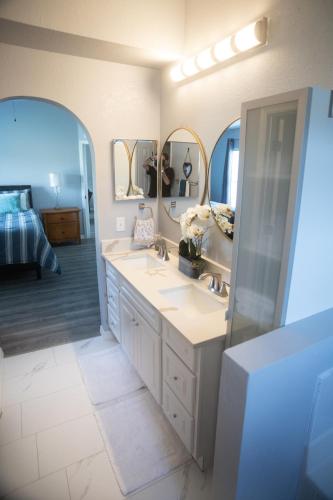 a bathroom with two sinks and two mirrors at Florida Suburban Oasis ~ Lk Mary/Sanford Florida! in Sanford
