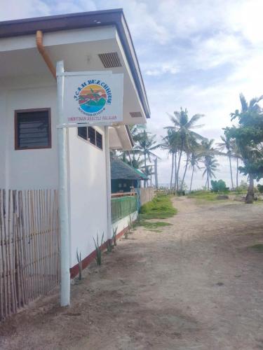 a building with a sign on the side of it at JCAH BEACH HOUSE free WiFi in Araceli