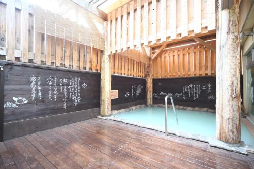 a large room with a swimming pool in a building at Hotel Naturwald Furano in Furano