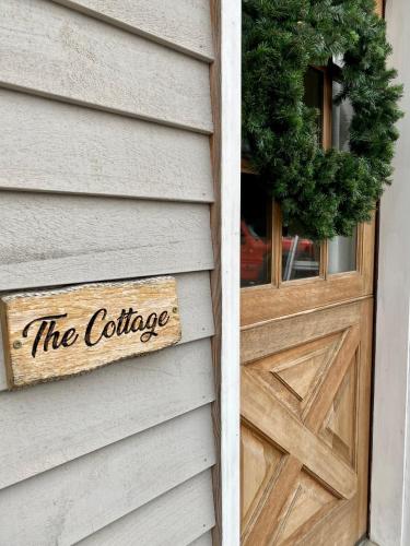 a wooden door with the coffee sign on a house at Letchworth Farm Guesthouses in Nunda