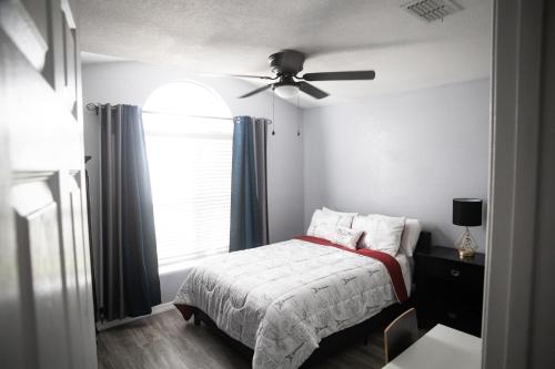 a bedroom with a bed and a ceiling fan at Florida Suburban Oasis ~ Lk Mary/Sanford Florida! in Sanford