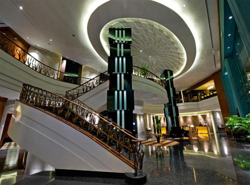 a lobby with a spiral staircase in a building at Eastin Hotel Kuala Lumpur in Petaling Jaya