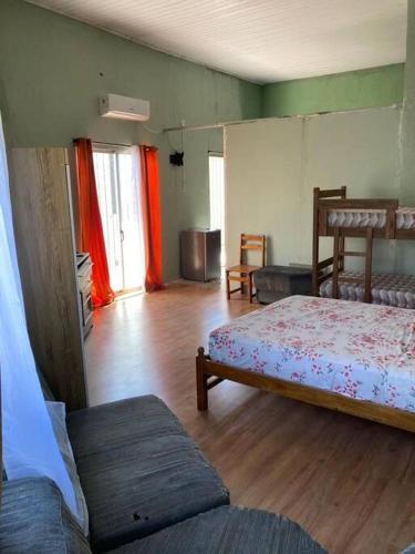 a living room with two beds in a room at N1 4 Apto 2 ambientes Céntrico in Artigas