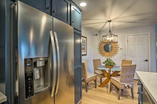 a kitchen with a stainless steel refrigerator and a table at Cozy-Chic Condo Walk to Beach and Park! in Dana Point