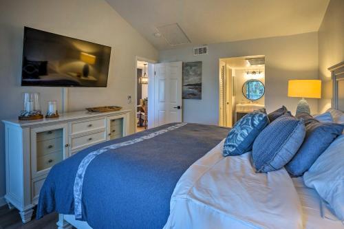a bedroom with a large bed with blue pillows at Cozy-Chic Condo Walk to Beach and Park! in Dana Point