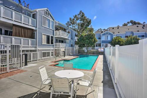 a patio with a table and chairs next to a pool at Cozy-Chic Condo Walk to Beach and Park! in Dana Point