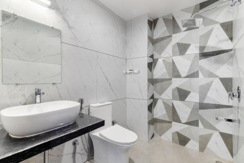 a white bathroom with a sink and a toilet at Seasons - A Boutique Hotel-Nearby Biological Park in Udaipur