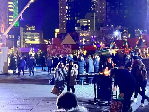 a crowd of people walking on a city street at night at 1406 Sainte Elisabeth in Montreal