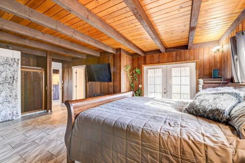 a bedroom with a bed and a wooden ceiling at Pet-Friendly Grants Pass Home with Hot Tub! in Grants Pass