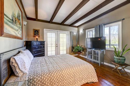 a bedroom with a bed and a flat screen tv at Pet-Friendly Grants Pass Home with Hot Tub! in Grants Pass