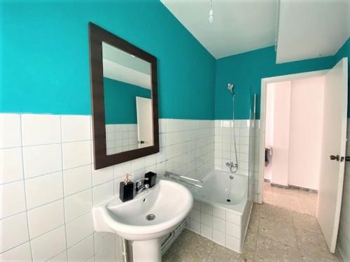 a bathroom with a sink and a mirror and a tub at casa culleredo in A Coruña