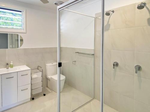 a bathroom with a glass shower stall and a toilet at 4 Bedroom House in Arcadia with huge Pool and Wifi 'Brookehaven' in Arcadia