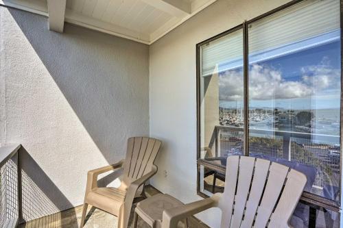 two chairs on a balcony with a view of the city at San Francisco Area Studio with Bay Views! in Emeryville