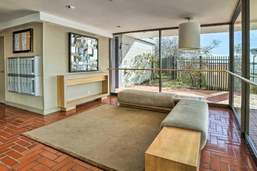 a living room with a couch and a large window at San Francisco Area Studio with Bay Views! in Emeryville