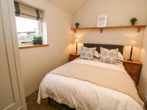 um quarto com uma cama com almofadas e uma janela em Five Wells Barn em Flagg