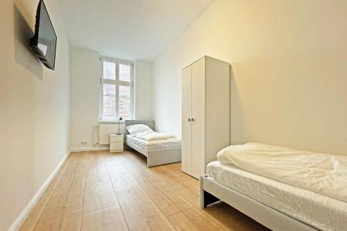 a bedroom with a bed and a cabinet and a window at Chic Apartment in Jüterbog in Jüterbog