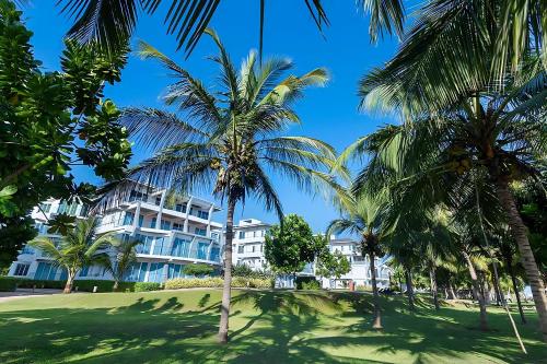 a building with palm trees in front of it at Beach Paradise Nilaveli in Trincomalee