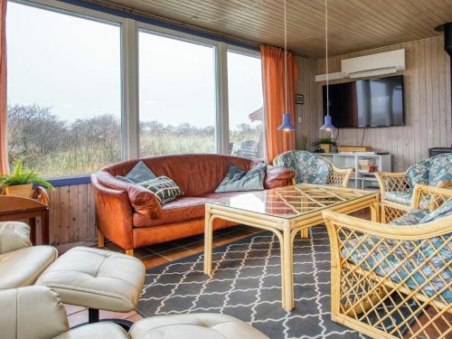 a living room with a couch and chairs and a table at 12 person holiday home in Hjørring-By Traum in Hjørring