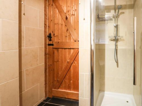 a bathroom with a shower and a sliding barn door at The Old Dairy in Herne Bay