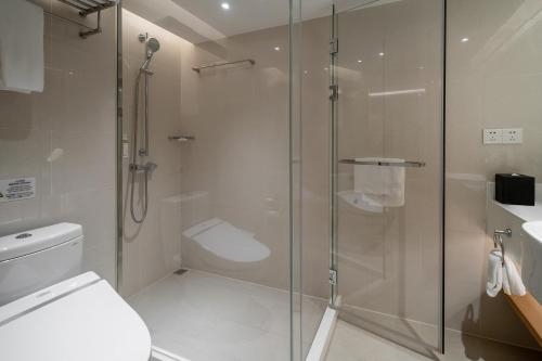 a bathroom with a shower and a toilet at Holiday Inn Shanghai Hongqiao Central by IHG in Shanghai