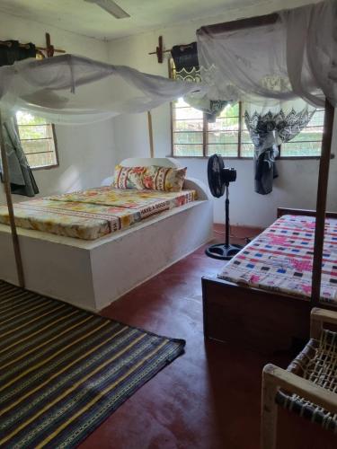 Ένα ή περισσότερα κρεβάτια σε δωμάτιο στο Mgeni Homestay