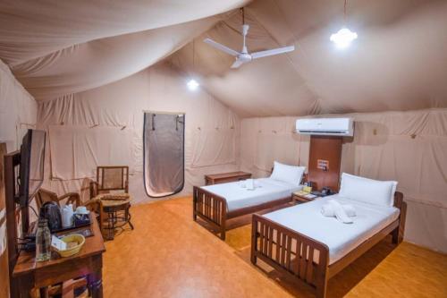 a room with two beds in a tent at My Village - Eco Rural Resort in Coimbatore