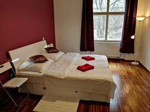 a bedroom with a bed with red pillows on it at 2 Bedrooms close Vyšehrad - Congress centrum in Prague
