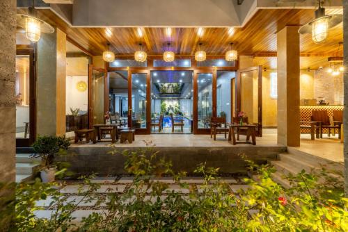 a lobby of a building with tables and chairs at Moon Sun Boutique Villa Hotel in Hue