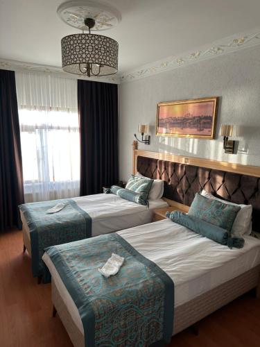 Ένα ή περισσότερα κρεβάτια σε δωμάτιο στο Blue Tuana Hotel Old City