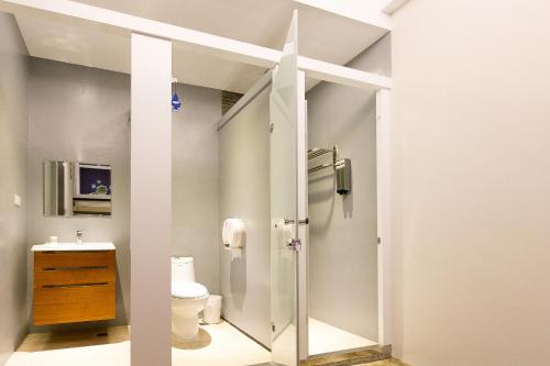 a bathroom with a shower and a toilet at Arch Inn in Hualien City