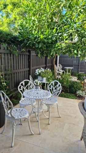 a table and two chairs and a table and chairs at Edward Lodge New Fam in Brisbane