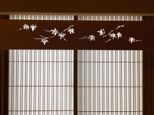 a window with a silhouette of birds on it at unsui 武雄蓬莱町 雲水 in Takeo