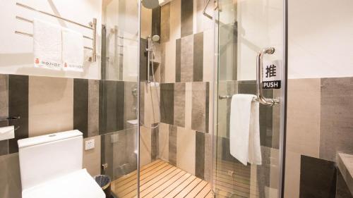 a bathroom with a glass shower with a toilet at Yunshan Villa in Huangshan Scenic Area